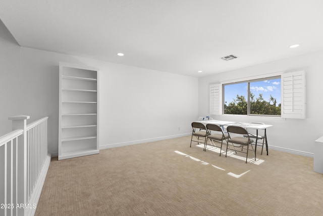 carpeted dining room with built in features