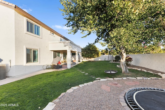 view of yard featuring central AC, a balcony, and a patio