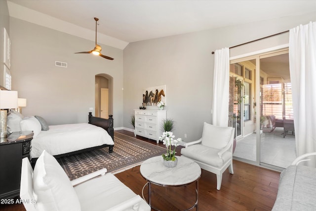 bedroom featuring visible vents, arched walkways, a ceiling fan, wood finished floors, and access to exterior