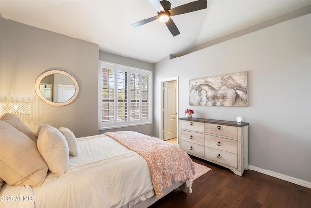 bedroom with lofted ceiling, baseboards, dark wood finished floors, and a ceiling fan