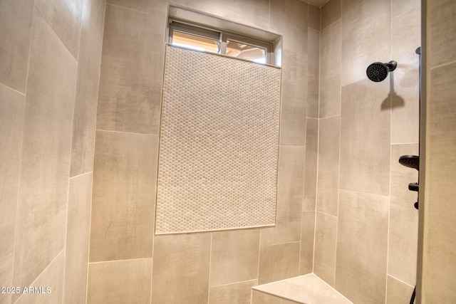 bathroom with tiled shower