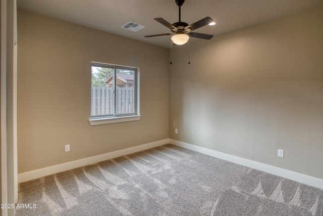 empty room with ceiling fan and carpet floors