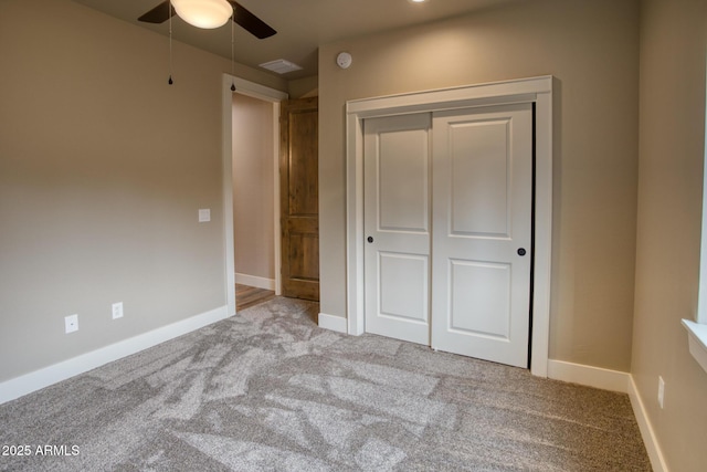 unfurnished bedroom with a closet, light colored carpet, and ceiling fan