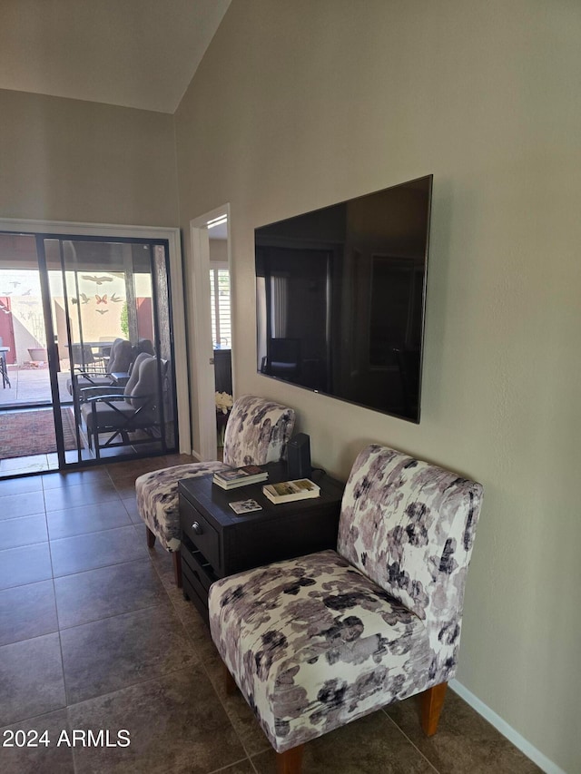 tiled living room featuring lofted ceiling