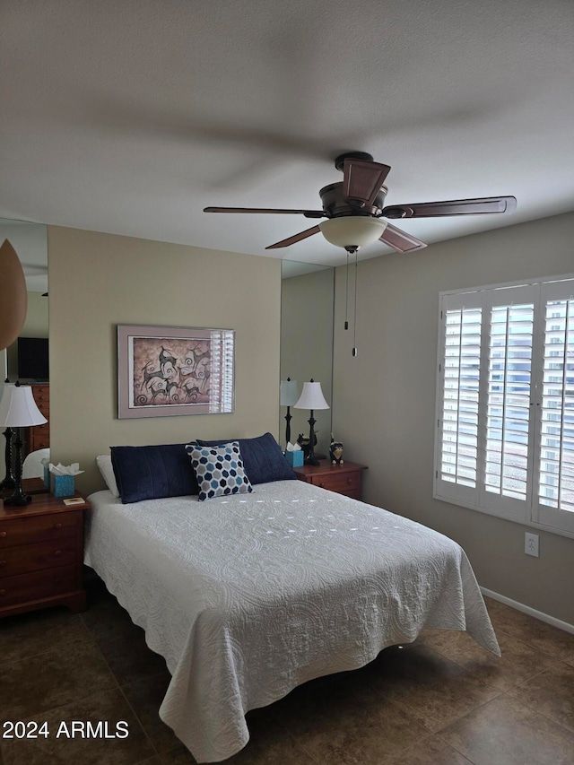 tiled bedroom with ceiling fan