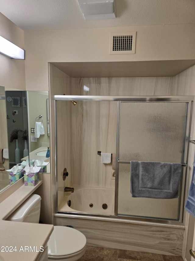 full bathroom with vanity, toilet, and enclosed tub / shower combo