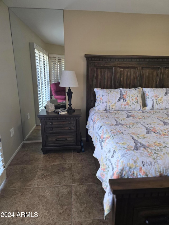 bedroom with dark tile patterned flooring