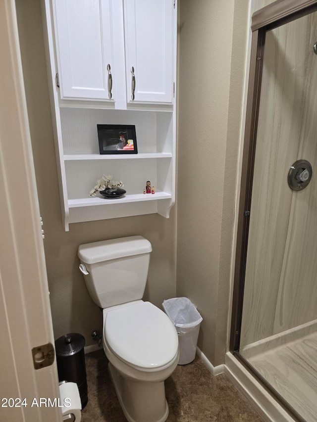 bathroom featuring toilet and walk in shower