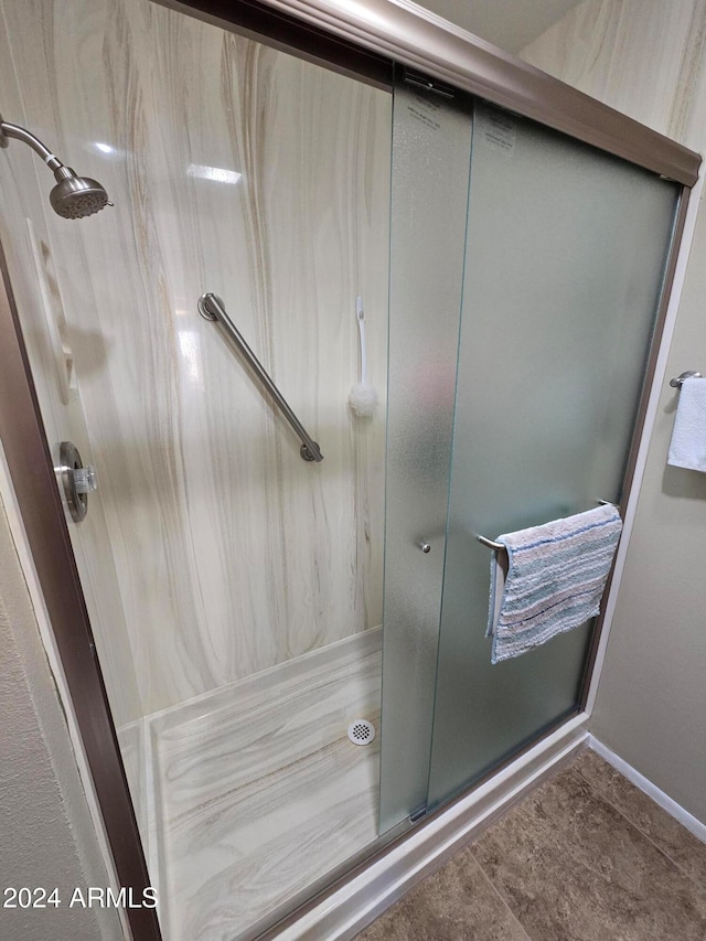 bathroom featuring a shower with door