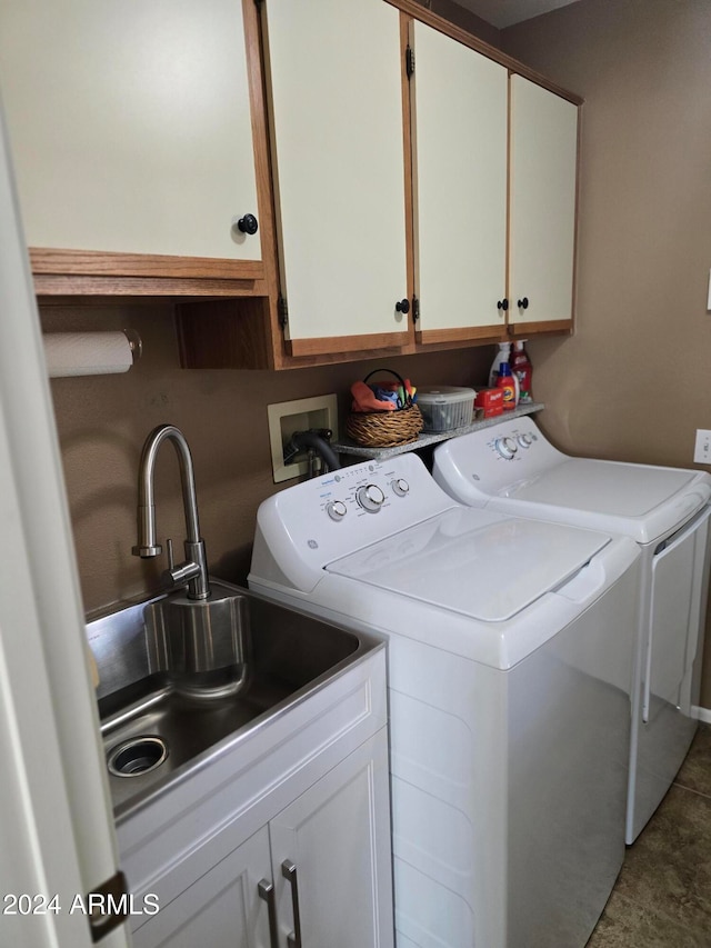 laundry room with cabinets, washing machine and dryer, and sink