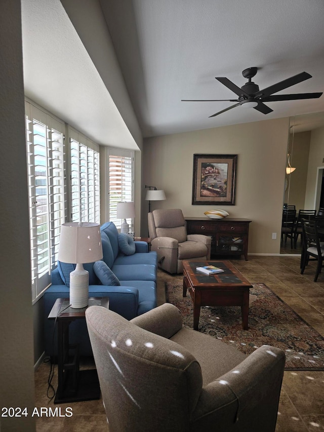 living room featuring ceiling fan and lofted ceiling