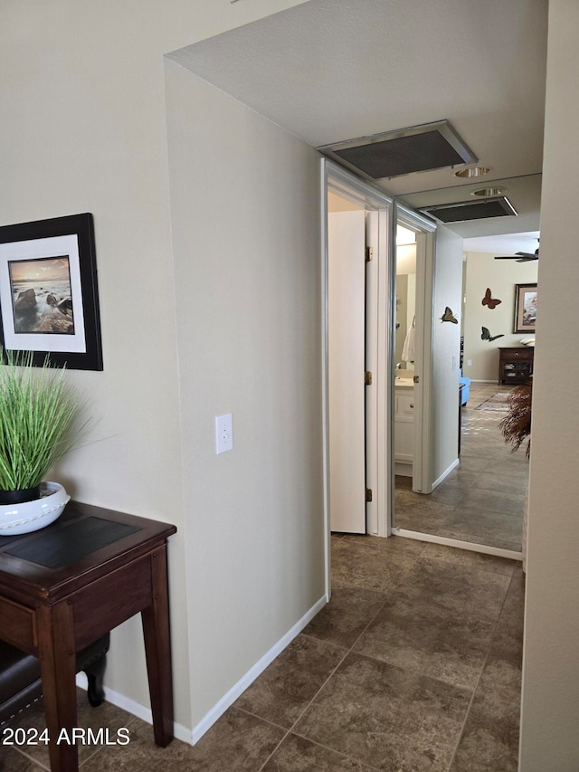 hallway with dark tile patterned floors