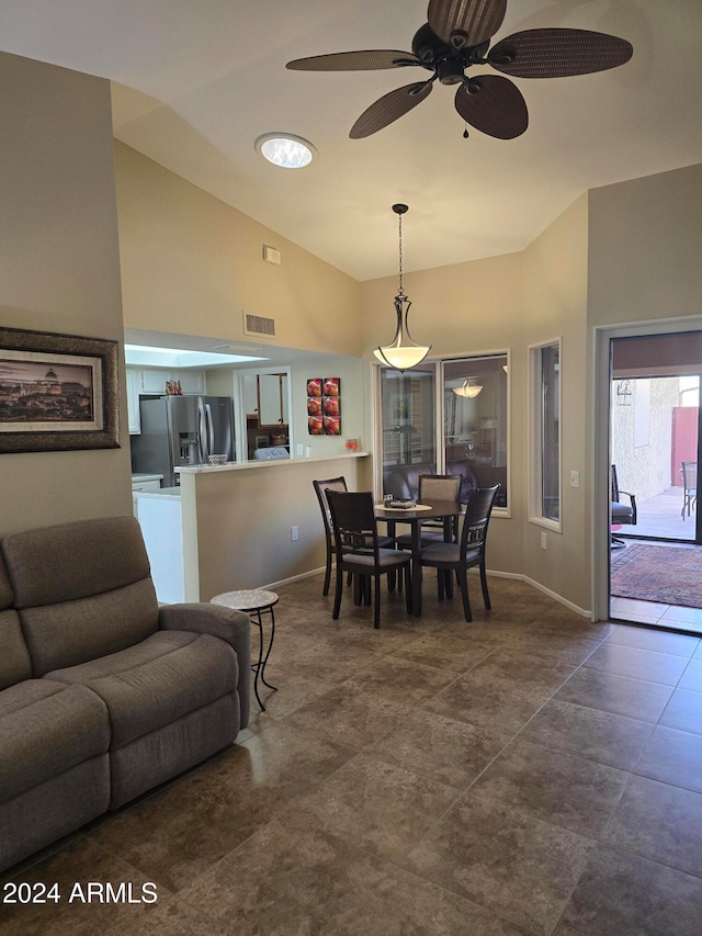 dining room featuring ceiling fan and lofted ceiling