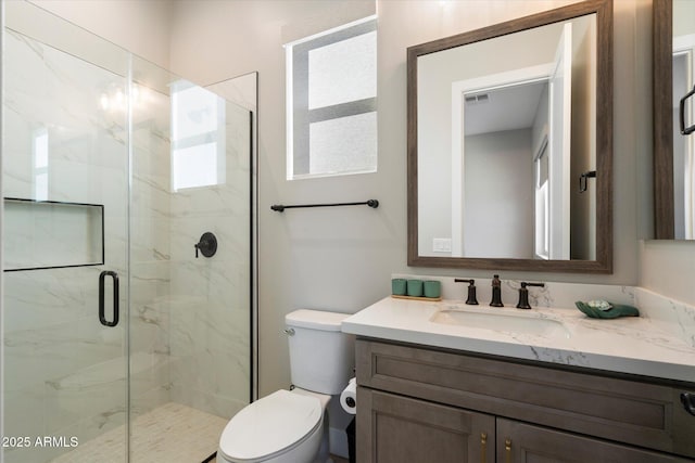 bathroom with toilet, a shower with door, and vanity