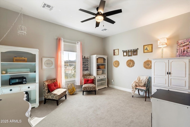 sitting room featuring light carpet and ceiling fan