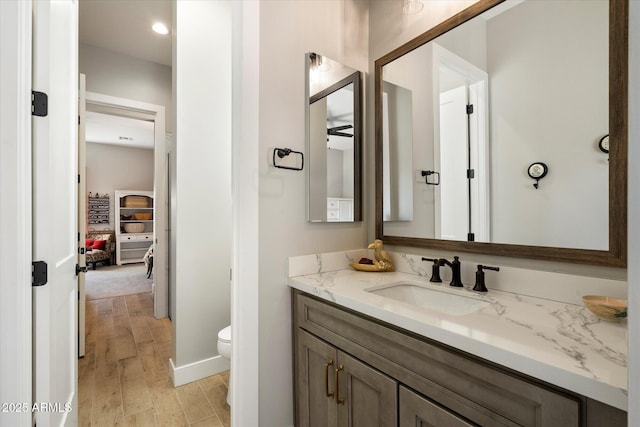 bathroom featuring toilet and vanity