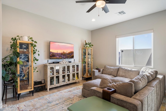 living room with ceiling fan and wood-type flooring