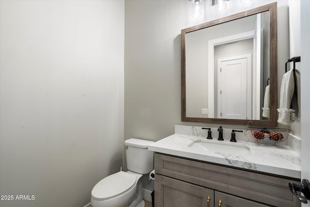 bathroom with toilet and vanity