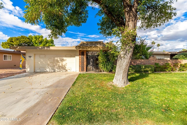 view of front of home featuring a front lawn and a garage