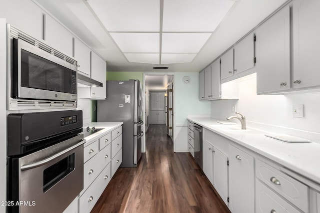 kitchen featuring dark wood-type flooring, white cabinetry, and stainless steel appliances