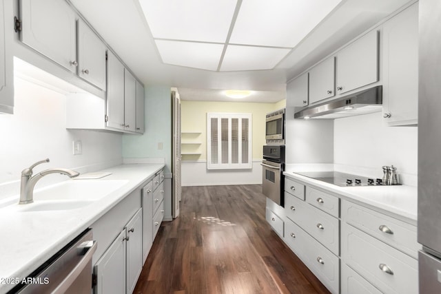 kitchen featuring dark wood-type flooring, sink, white cabinetry, and appliances with stainless steel finishes