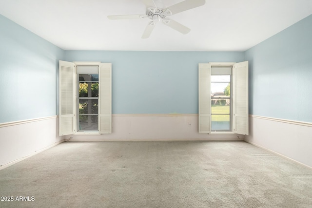 spare room featuring ceiling fan and light colored carpet