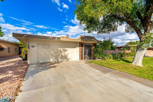 view of front of house with a garage and a front yard