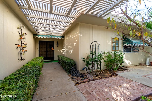 entrance to property featuring a pergola