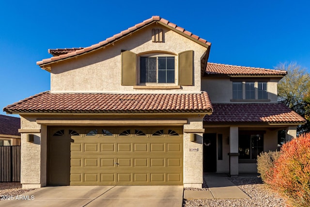 mediterranean / spanish-style house with a garage