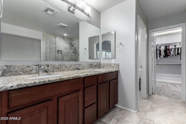 bathroom featuring walk in shower and vanity