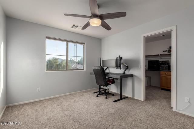 carpeted office space with ceiling fan