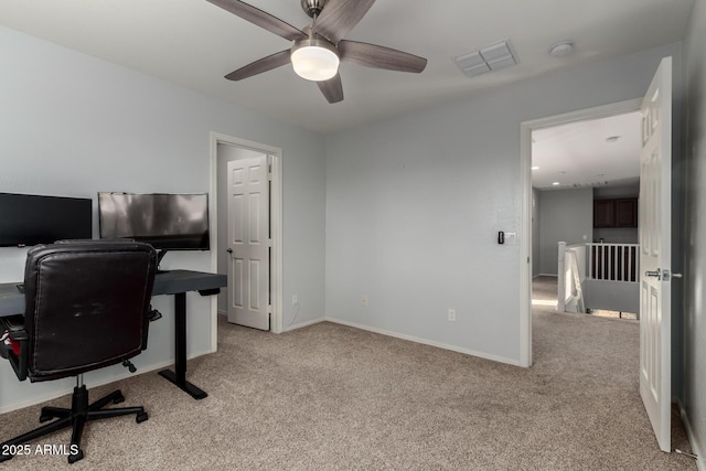 carpeted home office featuring ceiling fan