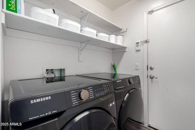 washroom with washing machine and clothes dryer