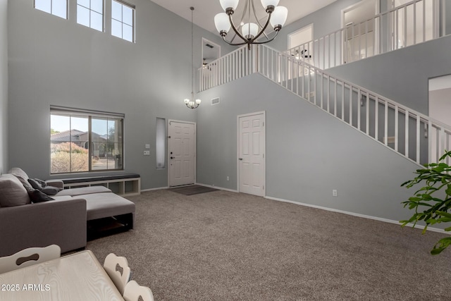 carpeted living room with an inviting chandelier and a towering ceiling