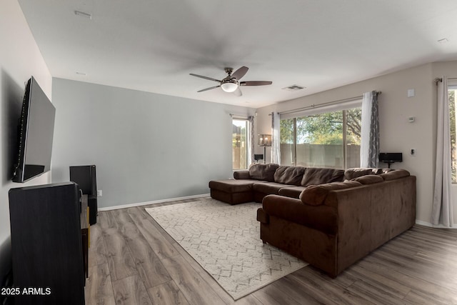 living room featuring ceiling fan and hardwood / wood-style floors