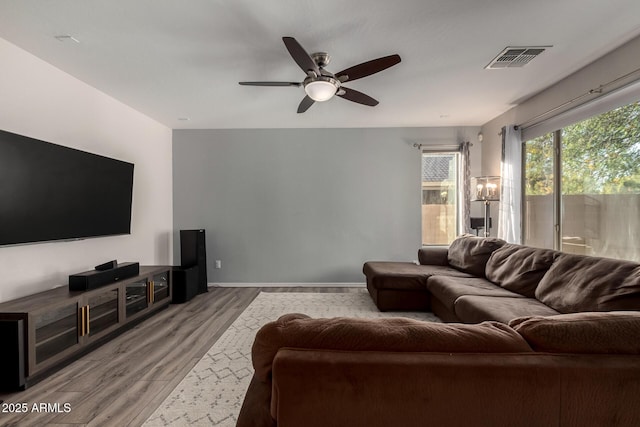 living room featuring ceiling fan and light hardwood / wood-style floors