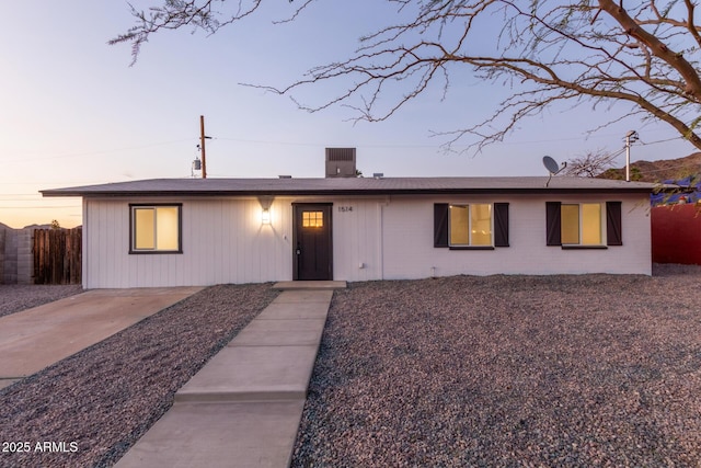 single story home featuring fence