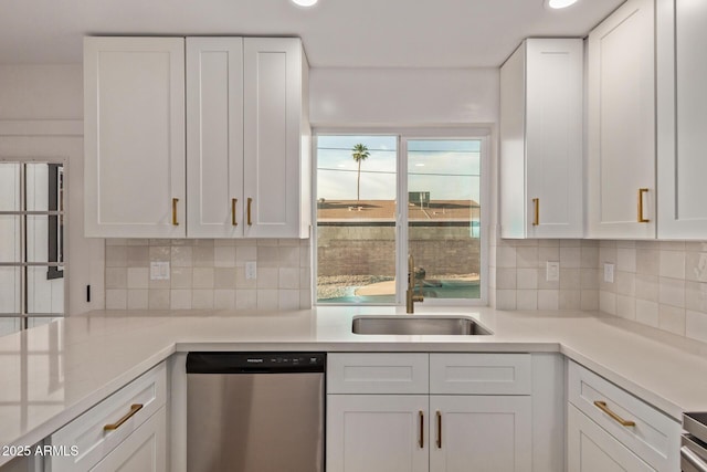 kitchen with white cabinetry, a sink, light countertops, and dishwasher