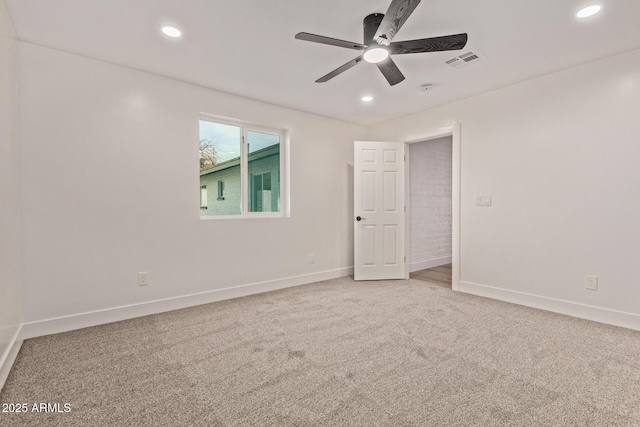 empty room with baseboards, visible vents, ceiling fan, and carpet floors