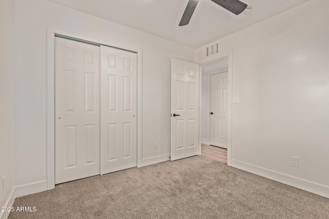 unfurnished bedroom featuring baseboards, visible vents, a closet, and carpet floors