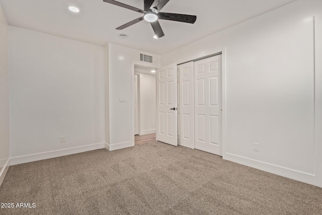 unfurnished bedroom with a closet, carpet flooring, baseboards, visible vents, and ceiling fan