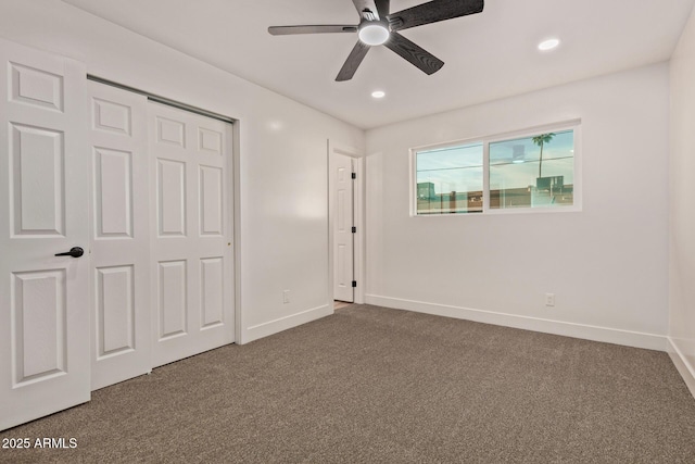 unfurnished bedroom with a closet, baseboards, dark carpet, and recessed lighting