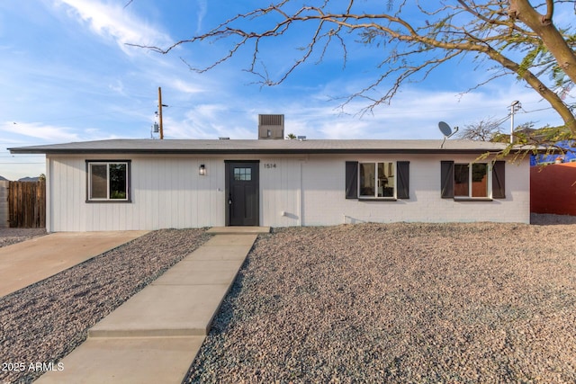 ranch-style house featuring fence