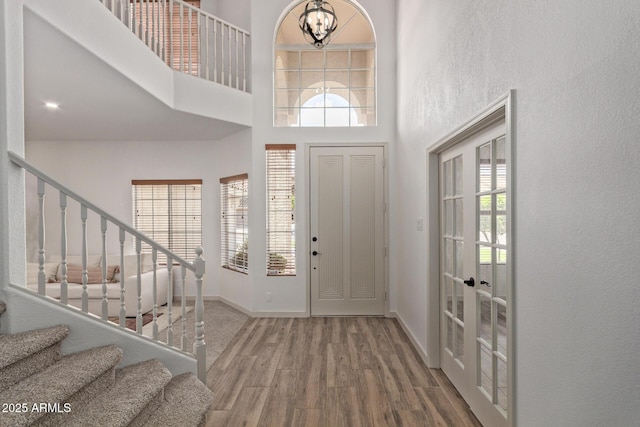 453 E Baylor Ln, Gilbert, AZ 85296 - entrance foyer with wood finished floors, stairs, a chandelier, a towering ceiling, and baseboards