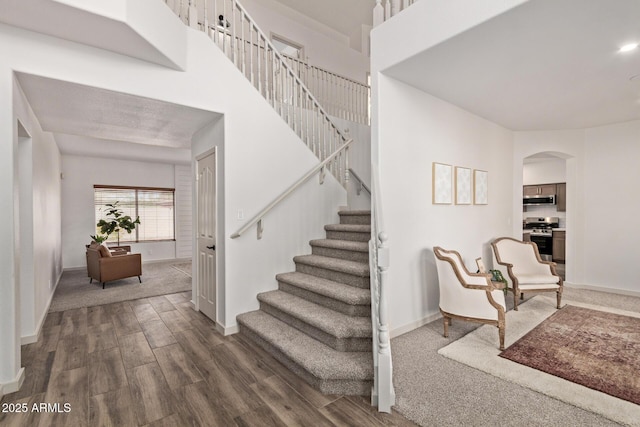 453 E Baylor Ln, Gilbert, AZ 85296 - stairs featuring baseboards, wood finished floors, and arched walkways