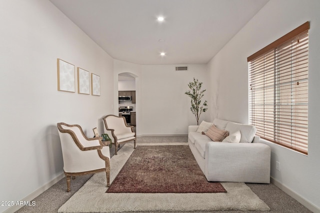 453 E Baylor Ln, Gilbert, AZ 85296 - living area featuring arched walkways, carpet flooring, plenty of natural light, baseboards, and recessed lighting