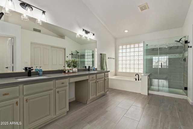 453 E Baylor Ln, Gilbert, AZ 85296 - bathroom featuring double vanity, a shower stall, a garden tub, lofted ceiling, and recessed lighting
