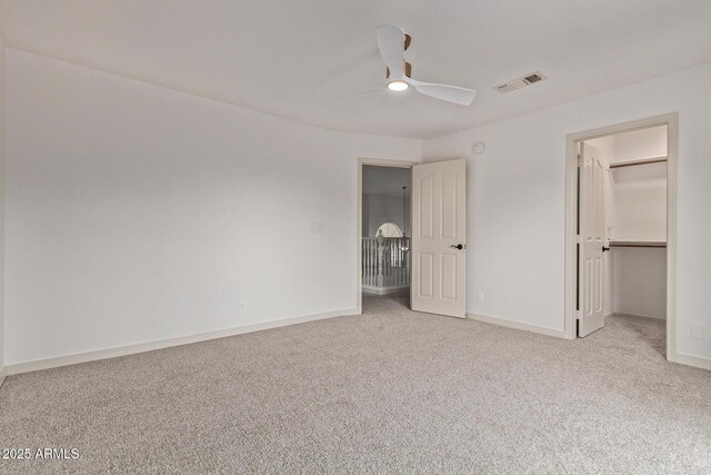 453 E Baylor Ln, Gilbert, AZ 85296 - unfurnished bedroom featuring carpet flooring, baseboards, a spacious closet, and a ceiling fan
