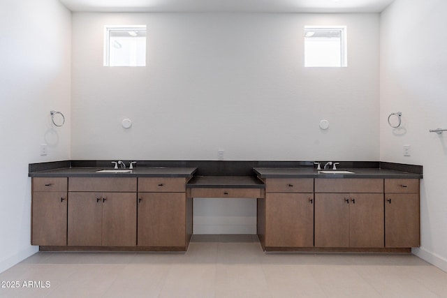 bathroom with vanity and baseboards