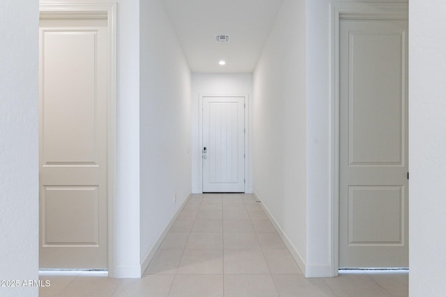 corridor with light tile patterned floors, visible vents, recessed lighting, and baseboards